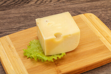 Emmental cheese over wooden board