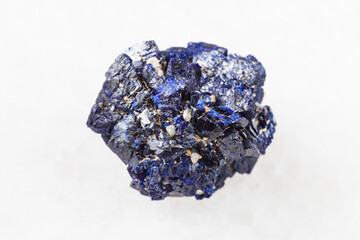 macro photography of sample of natural mineral from geological collection - raw Azurite mineral crystals from Jezkazgan, Kazakhstan on white marble background