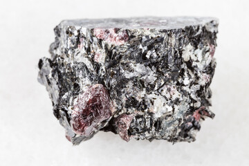 macro photography of sample of natural mineral from geological collection - raw red Garnet crystals...