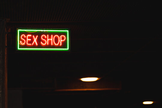 Red and Green Sex Shop Sign. Close up of Sex Shop Sign at Night.