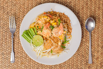 Top view of Thai traditional food  Pad Thai Noodles with shrimp in dish on wooden table