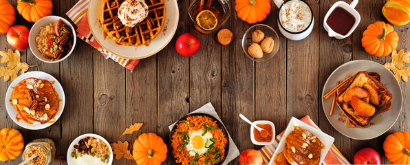 Assortment of autumn breakfast or brunch items. Frame against a dark wood banner background....