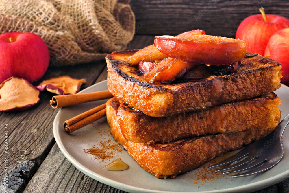 Poster stack of caramel apple cinnamon french toasts. side view table scene on a dark wood background. autu