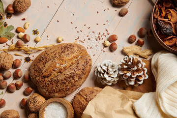 christmas decoration in rustic style and holiday background, still life on wooden backdrop, bread, nuts and other