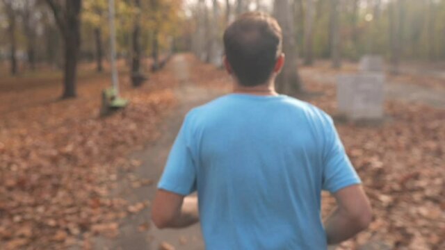 Man jogging and exercising in the park. Slow motion video.	
