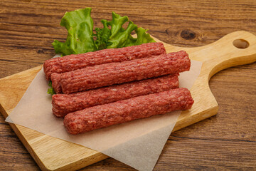 Raw beef sausages with spices