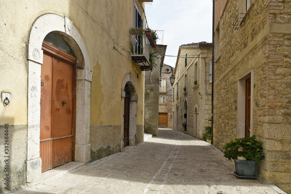 Wall mural a narrow street among the old houses of ferrazzano, a medieval village in the molise region.