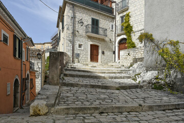 Fototapeta na wymiar A narrow street among the old houses of Ferrazzano, a medieval village in the Molise region. 