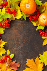 Naklejka na ściany i meble Seasonal background. Autumn composition with autumn maple leaves, pumpkin, nuts and berries on a slate background. Top view flat lay background with copy space.