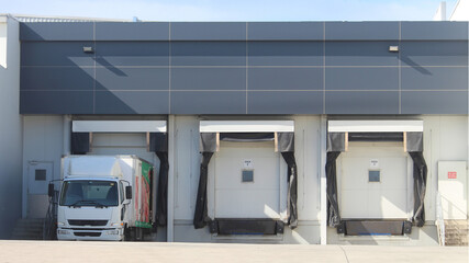Three refrigerated truck loading docks of a modern food manufacturing facility. Western Sydney Australia © Rose Makin