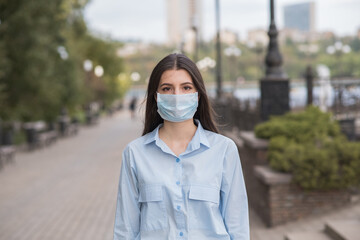 Portrait of a young and beautiful girl in a medical mask. Health care