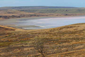 dry waterless outdoor scene, grasshill and saline lake