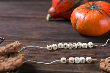 Autumn background with pumpkins on a rustic wooden background. Happy Thanksgiving with copy space. Happy Halloween text.