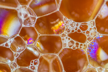 Air bubbles in the water and oil mixture create an artistic and imaginatively designed abstract...