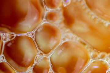 Air bubbles in the water and oil mixture create an artistic and imaginatively designed abstract...