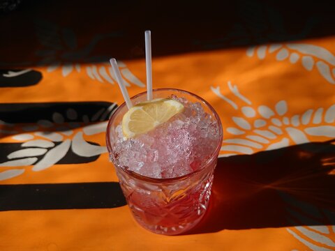 An iced strawberry cocktail with lemon on a table at a local bar pub restaurant