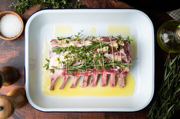tied and marinated lamb rack with herbs for roast