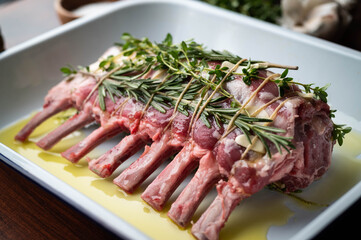 tied and marinated lamb rack with herbs for roast