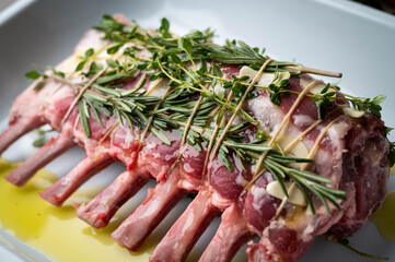 tied and marinated lamb rack with herbs for roast