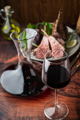 red wine glass with decanter and lamb rack