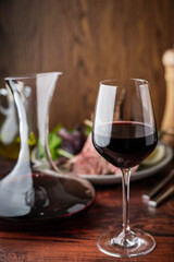 red wine glass with decanter and lamb rack