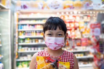 Asian little child girl shopping in mini mart