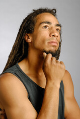 Contemplative young black man with dreadlocks