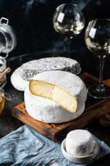 Various types of cheese composition. Gorgonzola, camembert, brie cheese. Roquefort, dor blue. Walnut and wine. Appetizer and gourmet food. Honey in jar