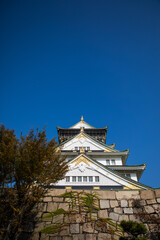 Osaka Castle facade in Osaka, Japan. Osaka Castle is one of the most famous landmarks and it played a role in the unification of Japan during 16th century.