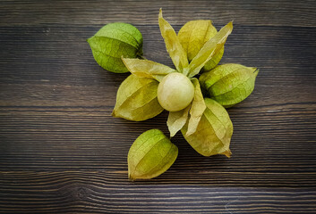 Physalis fruits on wooden background. Herbs medicine. 