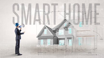 Young engineer holding blueprint with SMART HOME inscription, house planning concept