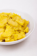 Stewed potato with spices in bowl.