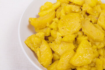 Stewed potato with spices in bowl.