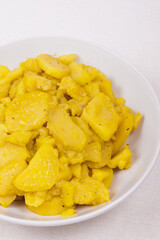 Stewed potato with spices in bowl.