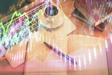 Stock market graph and top view computer on the table background. Multi exposure. Concept of financial education.