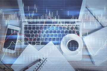 Stock market chart and top view computer on the table background. Double exposure. Concept of financial analysis.