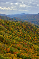 An aerial view down a valley in Seneca Rocks, WV shows deciduous trees in peak foliage with a...