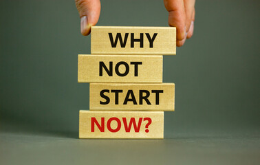 Male hand placing a block with word 'now' on a blocks tower with words 'why not start now'. Beautiful grey background. Copy space.