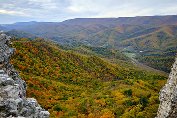 A view of the beautiful valley landscape in fall with peak foliage from the peak of the Chimney Top...