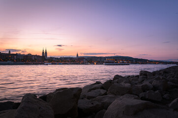 Budapest city skyline from the Danube river bank at sunset, Budapest, Hungary