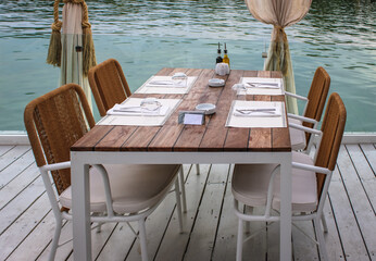 Table setting in a fine boat restaurant on water nackground