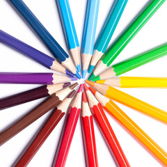 Naklejka premium sharpened colored pencils lie in a circle with their noses in the center, school supplies, LGBT symbol, close up.