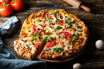tasty juicy pizza on wooden background. lots of meat and cheese. Mushroom pizza. Pepperoni pizza. Mozzarella and tomato. Italian dish. Italian food.