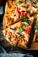 tasty juicy pizza on wooden background. lots of meat and cheese. Mushroom pizza. Pepperoni pizza. Mozzarella and tomato. Italian dish. Italian food.