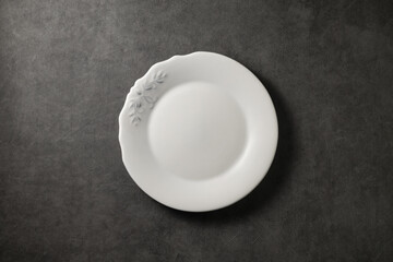 beautiful vintage plate on a dark gray concrete background, top view