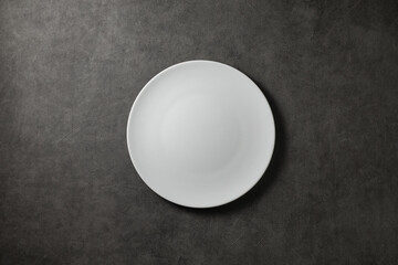 beautiful modern plate on a dark gray concrete background, top view