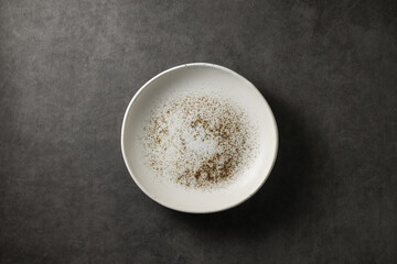 beautiful modern plate on a dark gray concrete background, top view