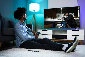African Man Watching TV Movie