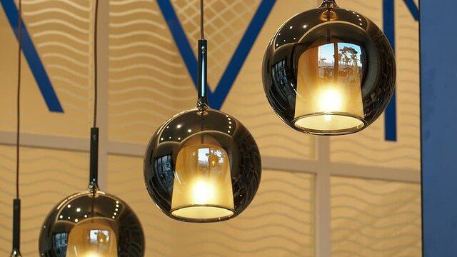 Breakfast in a bar on a September morning. Three lamps in the shape of a sphere as interior furnishings of the room for lighting.