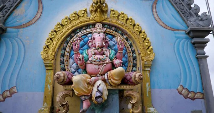 Ganesha statue slow-motion shot, gimbal shot of hindu god Ganesha hinduism holy statue in Penang island Malaysia